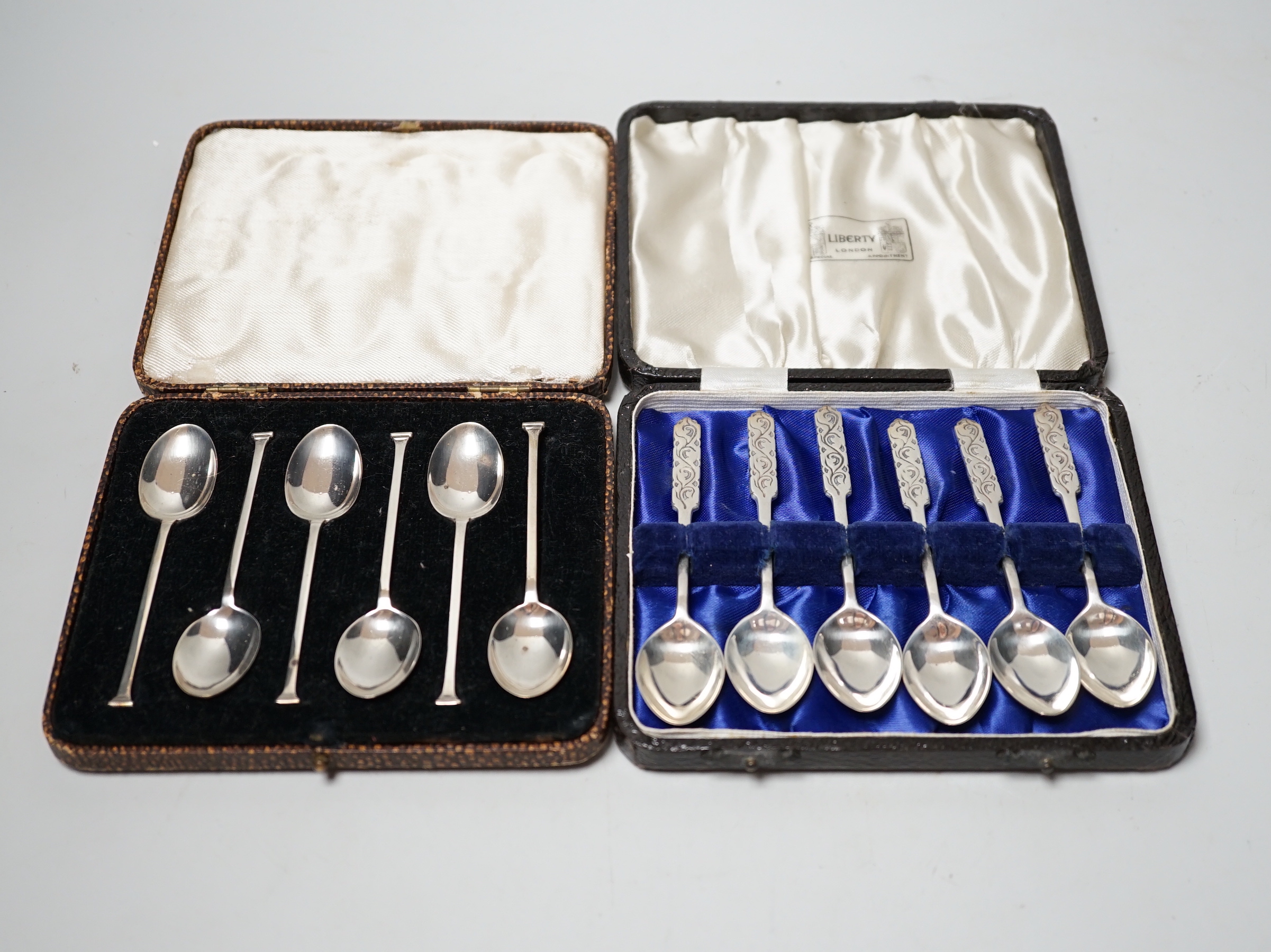 Two cased sets of six silver teaspoons including J.A. Restall Ltd, Birmingham, 1945, retailed by Liberty & Co.